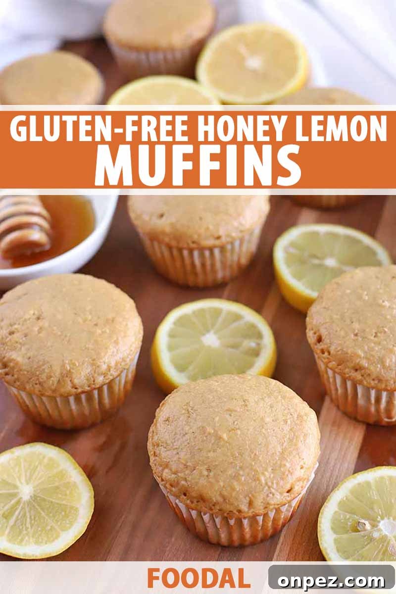 Vertical image of muffins and lemon slices with a white cloth and a small white ceramic bowl of honey with a wooden dipper, on a wood surface.
