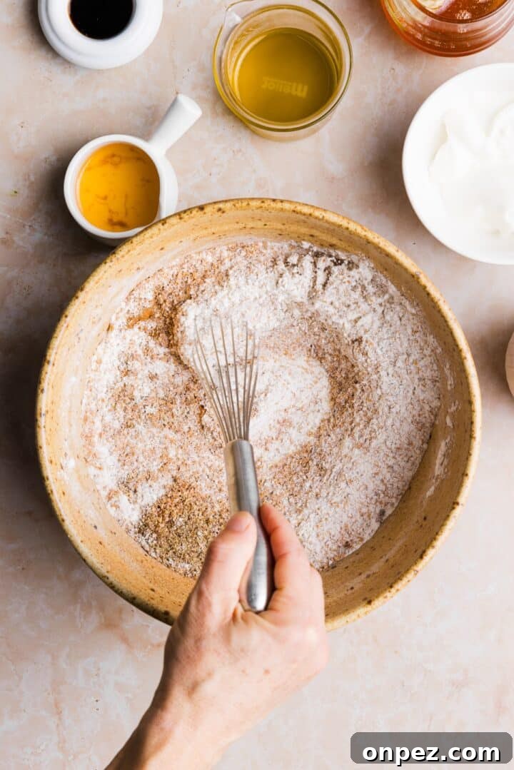 Moist Honey Bran Muffins Recipe 5 Dry ingredients being whisked together in a large mixing bowl