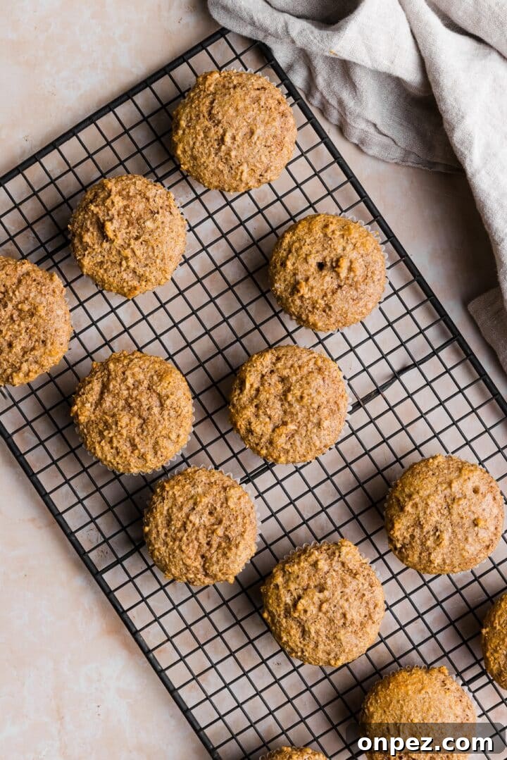 Moist Honey Bran Muffins Recipe 9 Cooked honey bran muffins on a beige marble counter