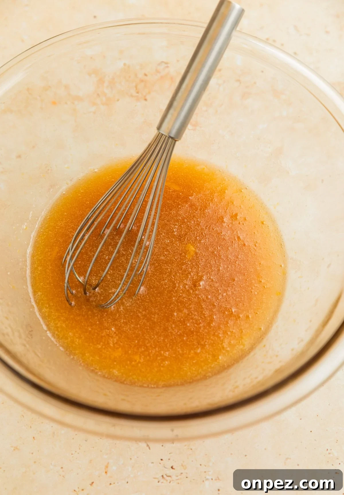 Butter, egg, oil and maple whisked together in glass bowl.