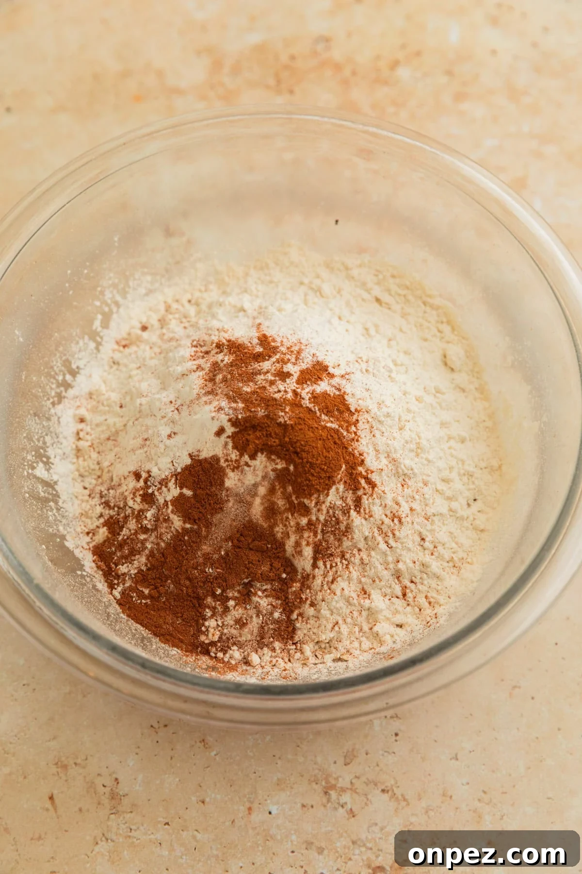 Cinnamon, flour and quick oats in bowl before stirring.