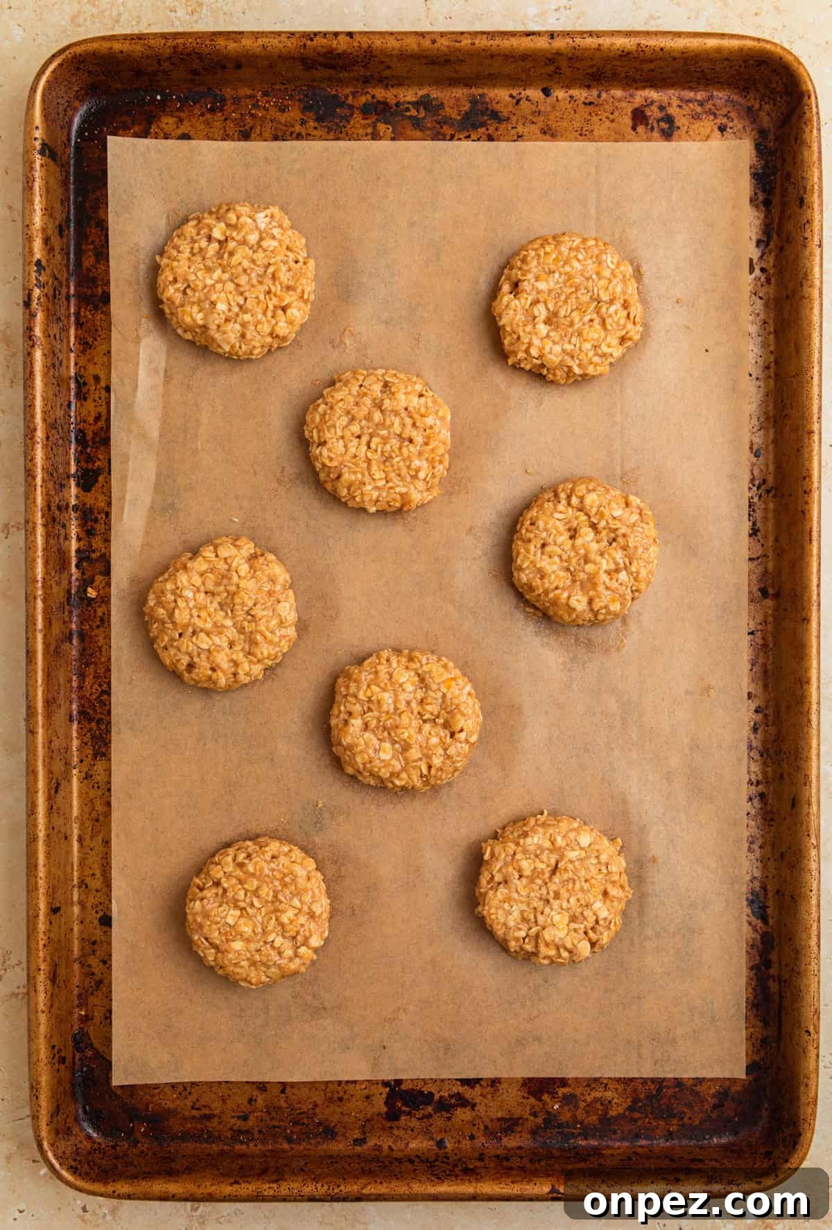 Cookie sheet with breakfast cookie dough arranged on parchment.