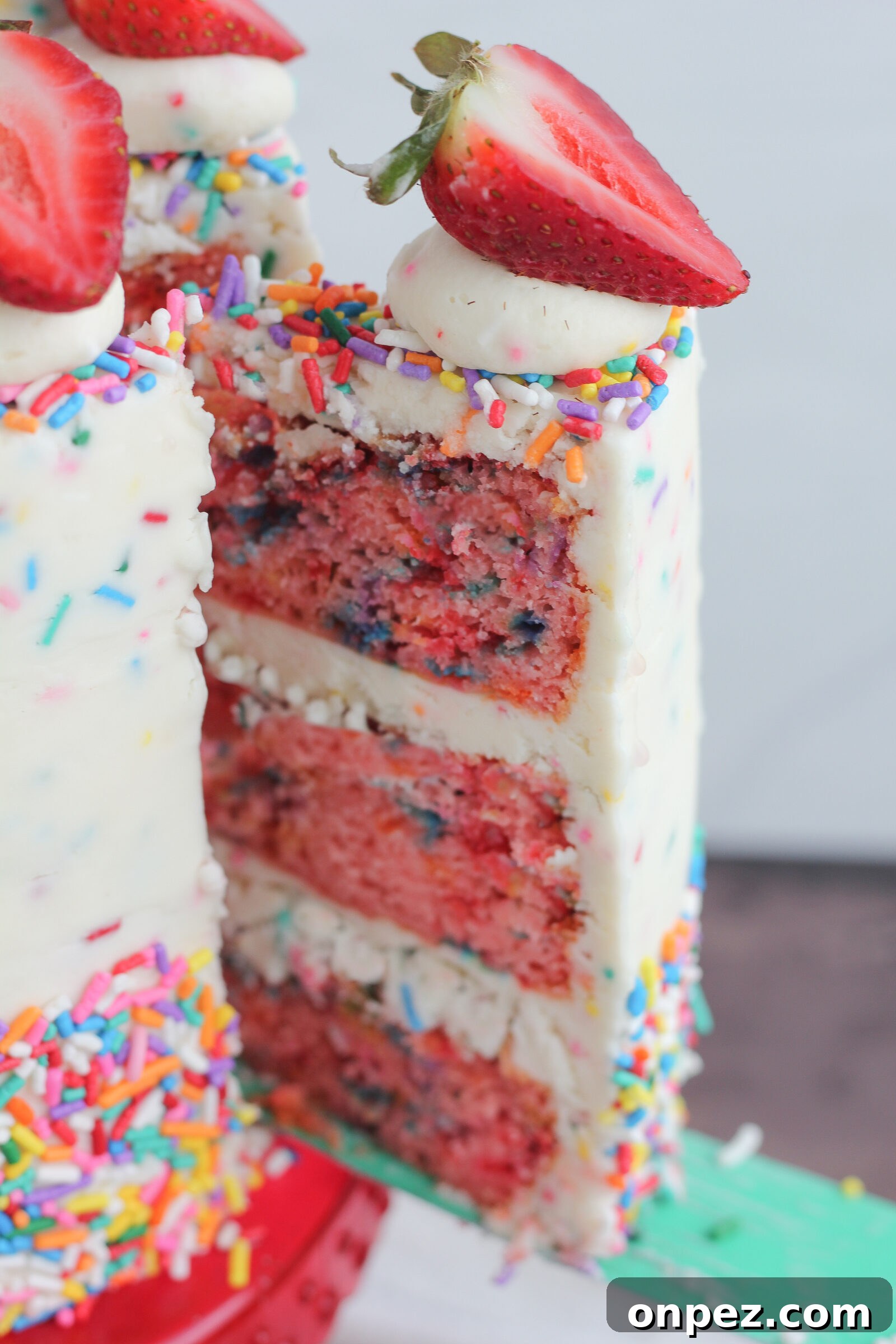 Finished strawberry funfetti cake with strawberries