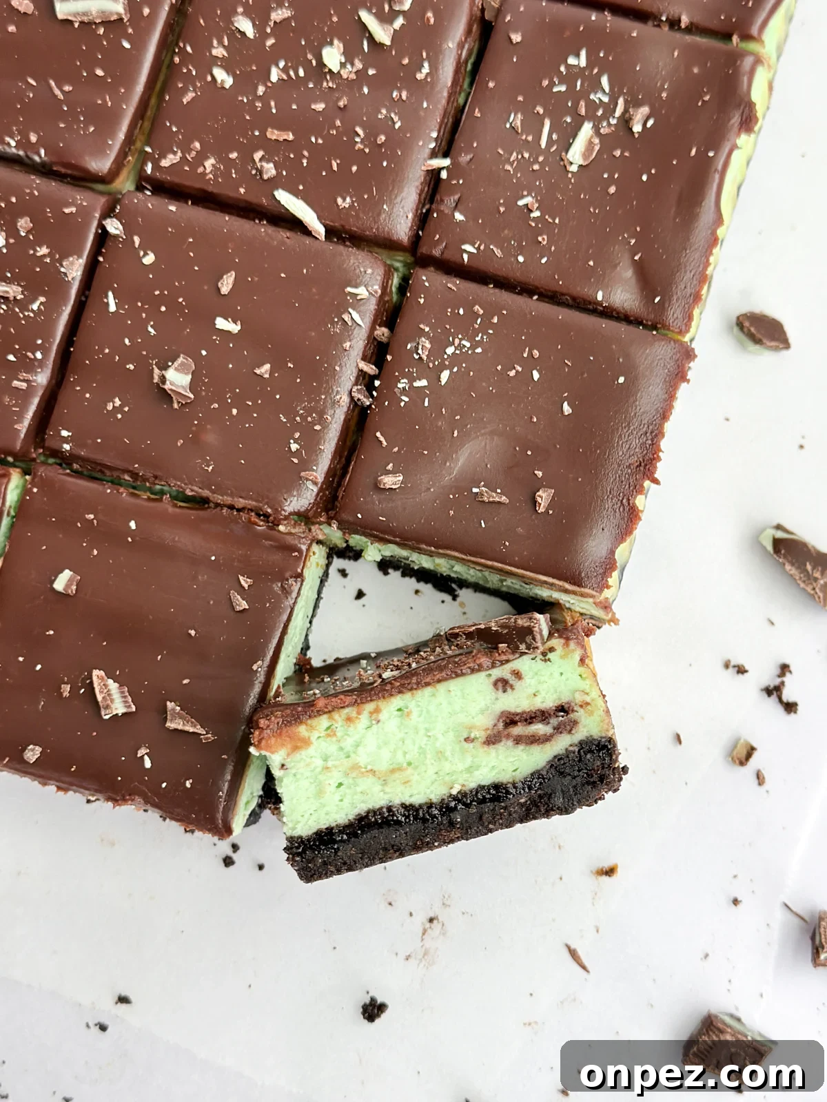 Decadent Chocolate Mint Cheesecake Bars 2 a close up of a square of chocolate mint cheesecake turned diagonal to see the layers.