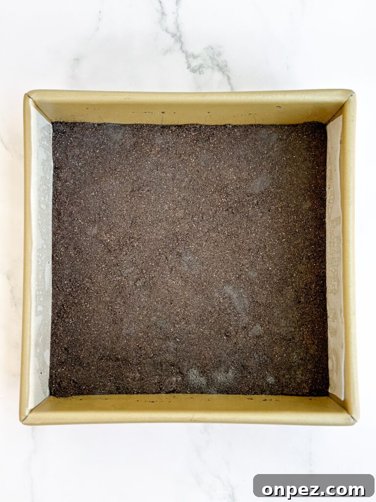 Decadent Chocolate Mint Cheesecake Bars 5 oreo cookie crust in baking pan.