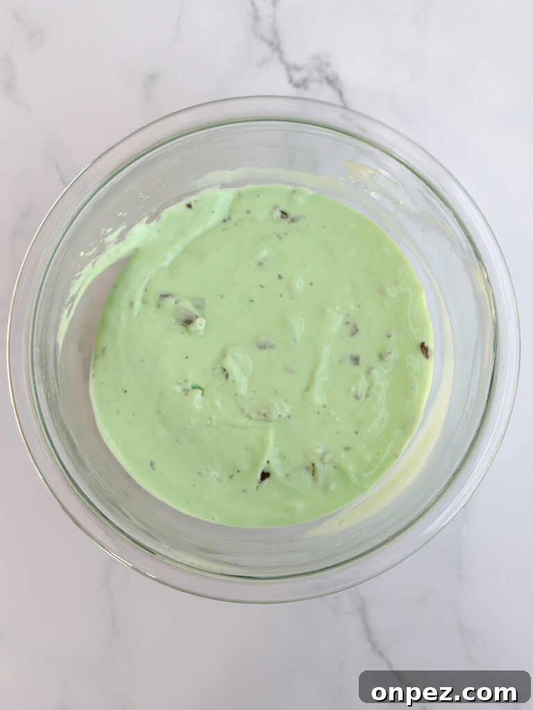 Decadent Chocolate Mint Cheesecake Bars 8 cheesecake after turning green and andes mints mixed in.