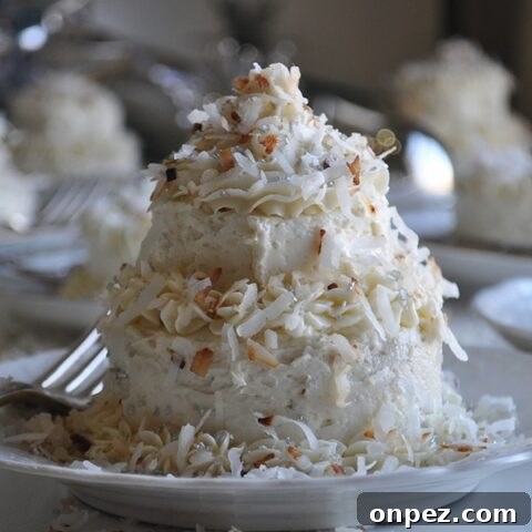 A mini Coconut Layer Cake frosted with Maple Italian Meringue Buttercream.