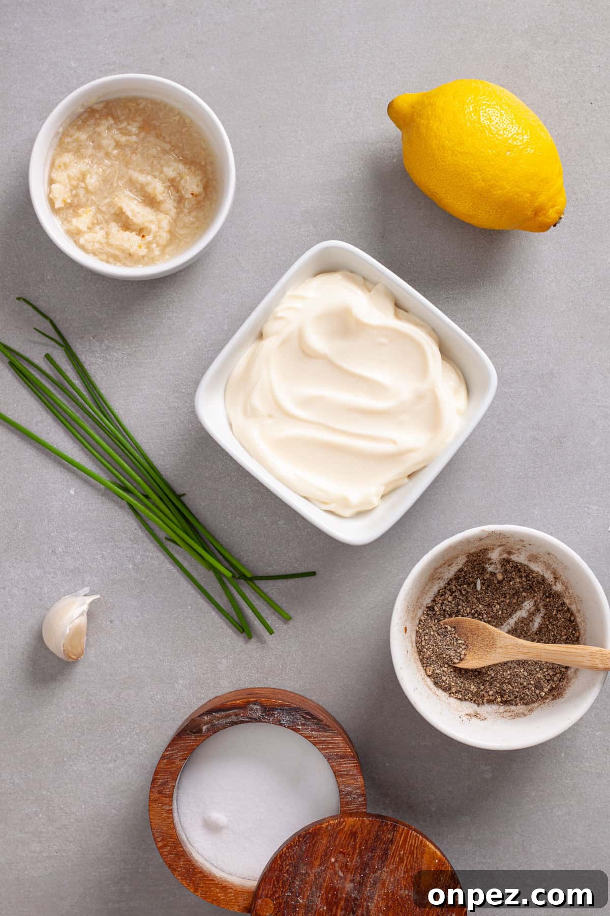 Creamy Horseradish Aioli Recipe for Roasts & Sandwiches 3 Ingredients for horseradish aioli on a gray table.