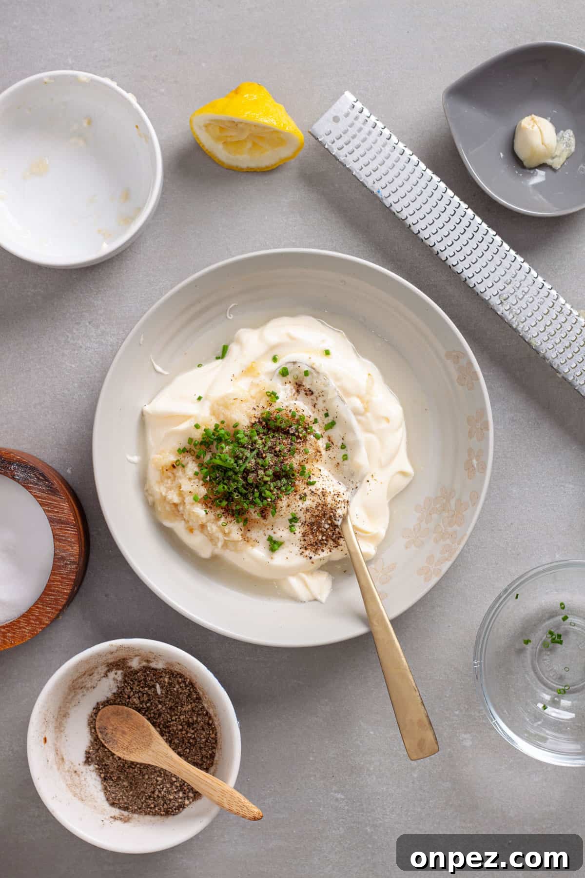 Creamy Horseradish Aioli Recipe for Roasts & Sandwiches 4 A small mixing bowl with ingredients for a horseradish aioli.