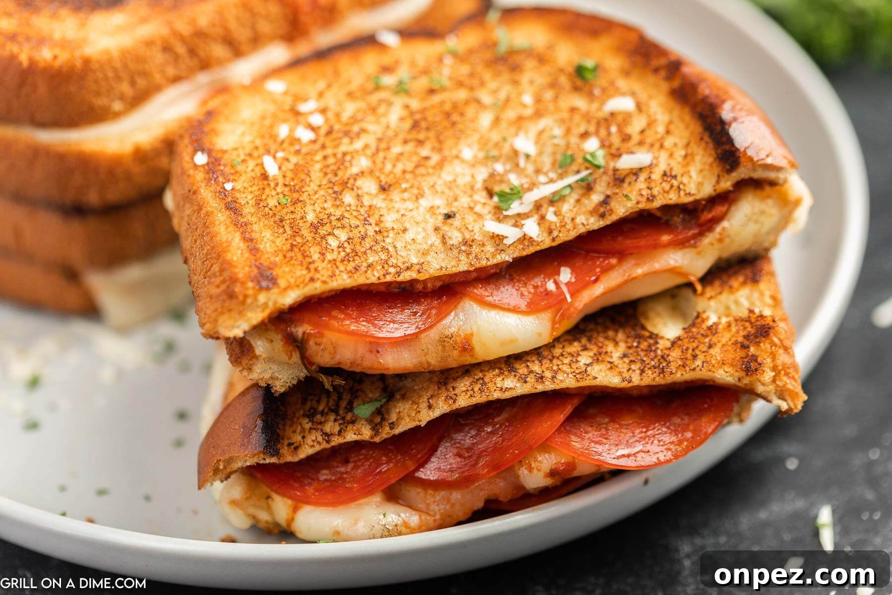 Pizza Grilled Cheese Sandwich cut in half on a plate