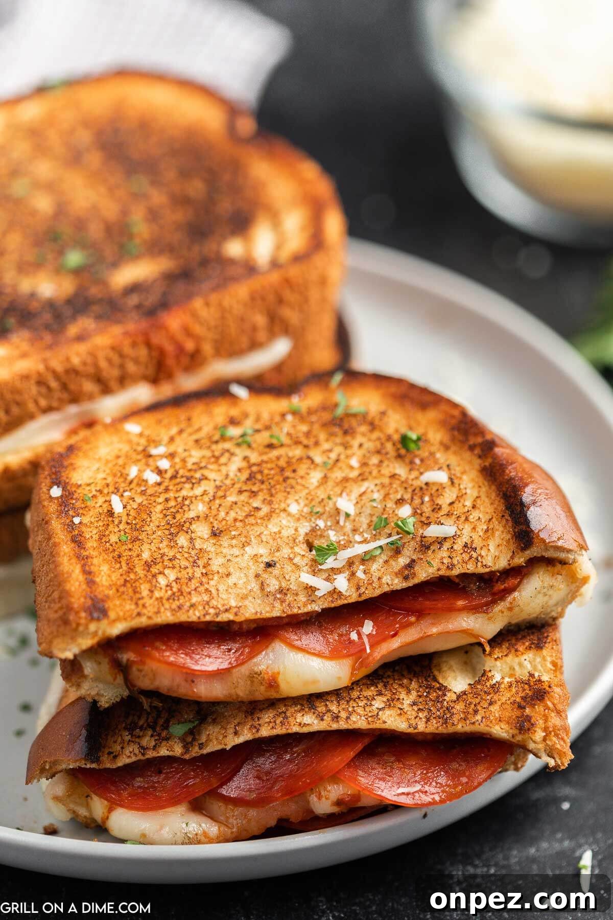 Pizza Grilled Cheese stacked on a plate