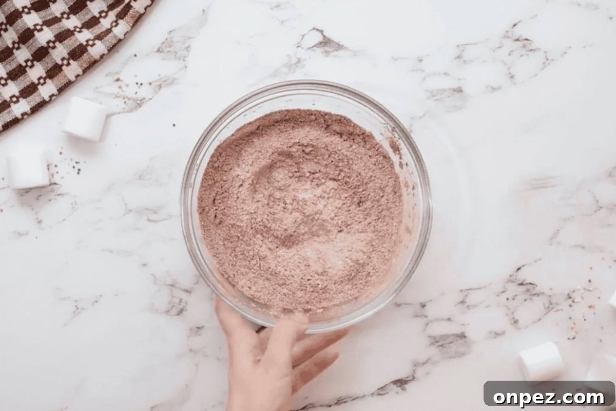 Hot Cocoa Cookies Recipe: Rich Chocolate Chip Cookies 5 dry ingredients for hot chocolate cookies in a glass bowl.