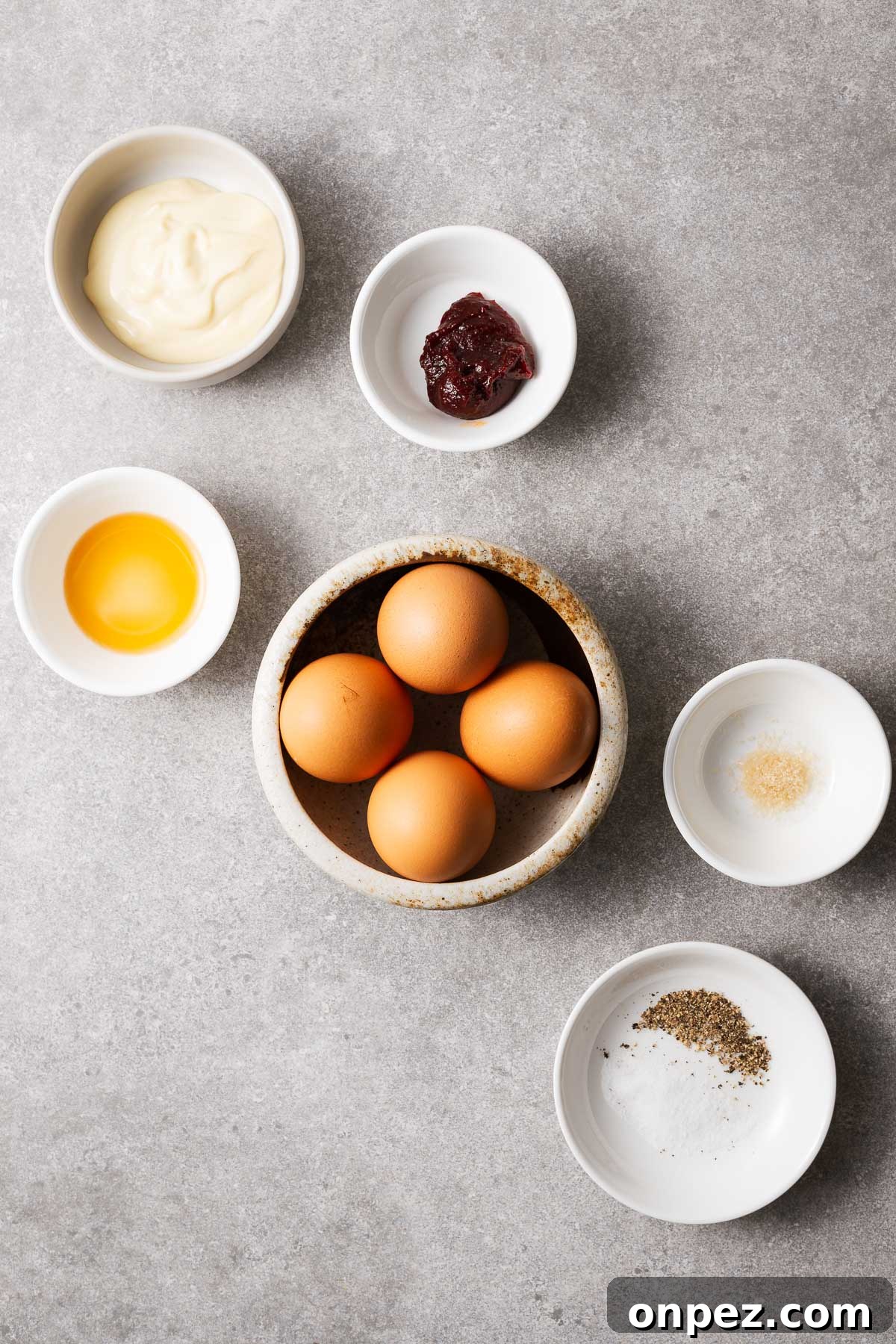 Ingredients for easy gochujang eggs including eggs, gochujang, mayonnaise, sesame oil, brown sugar and seasoning.