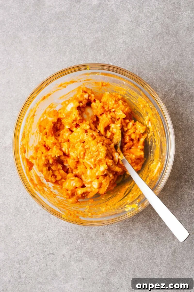 Gochujang egg salad mixture in a glass bowl.