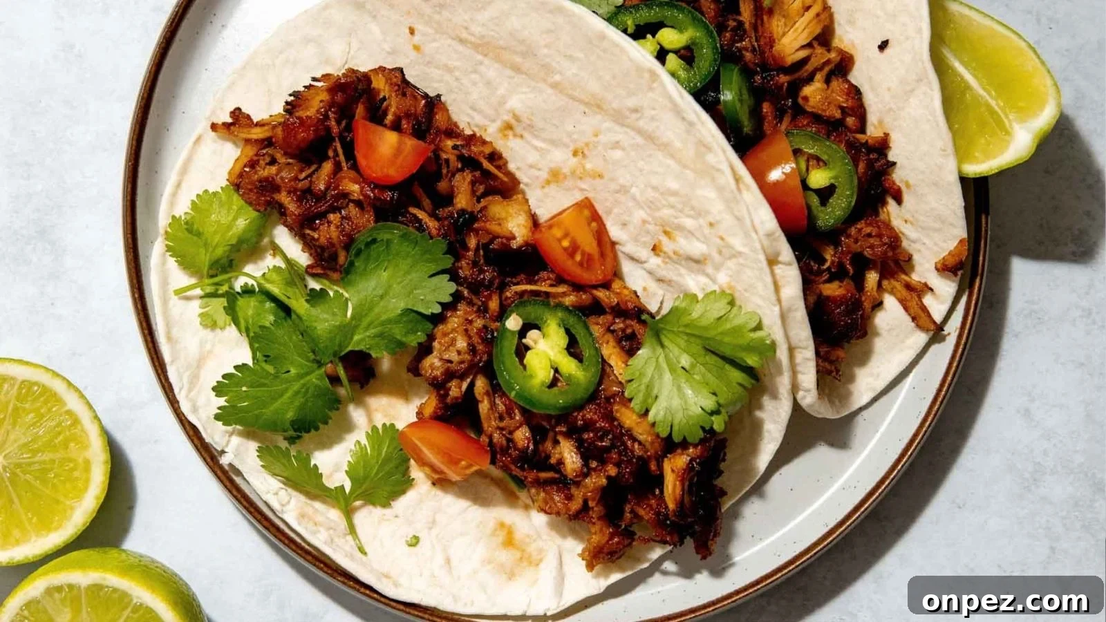 Dutch oven carnitas cooked until juicy with crisp browned edges.