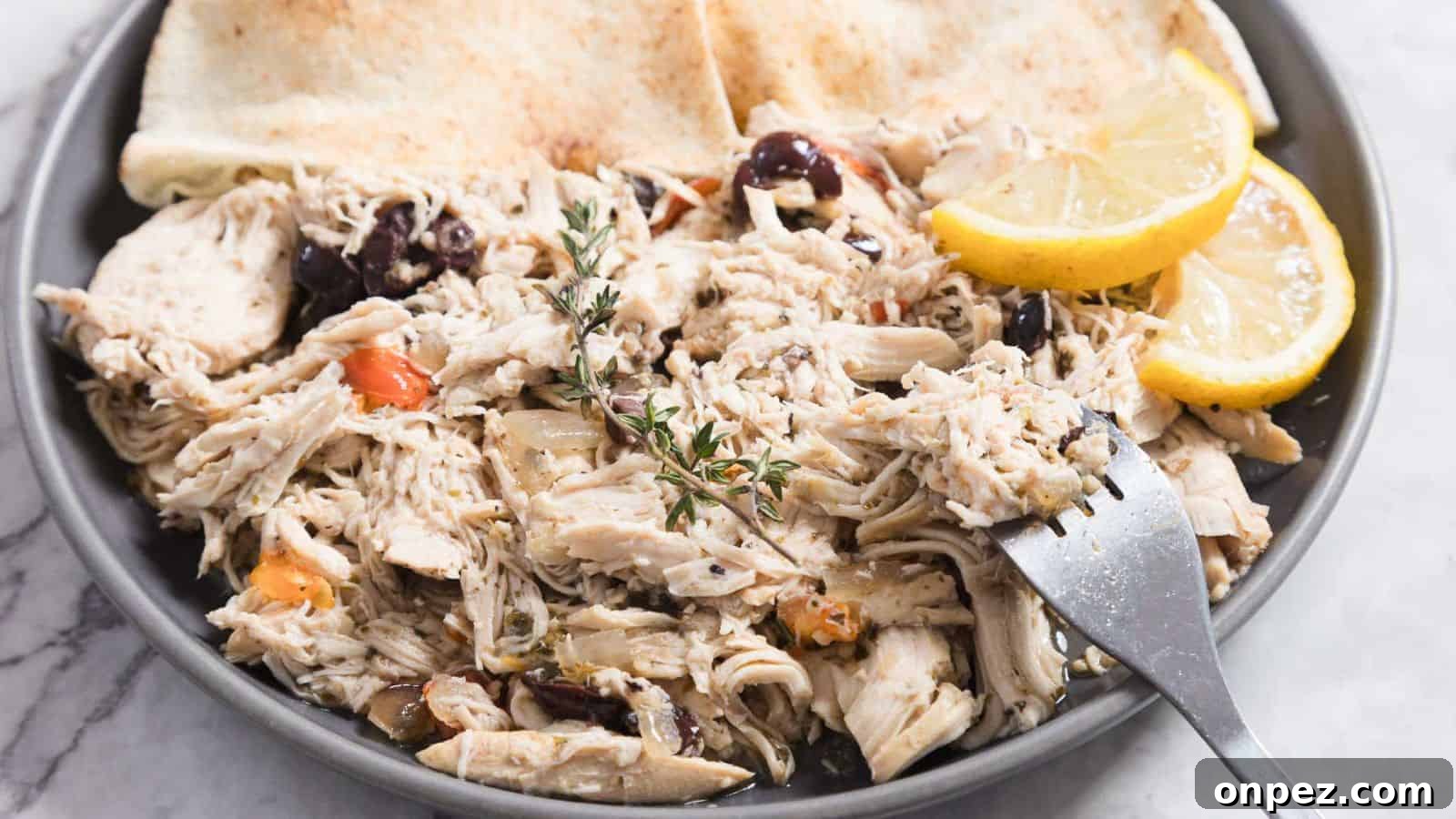 Slow cooker Greek chicken cooked tender with herbs and lemon.