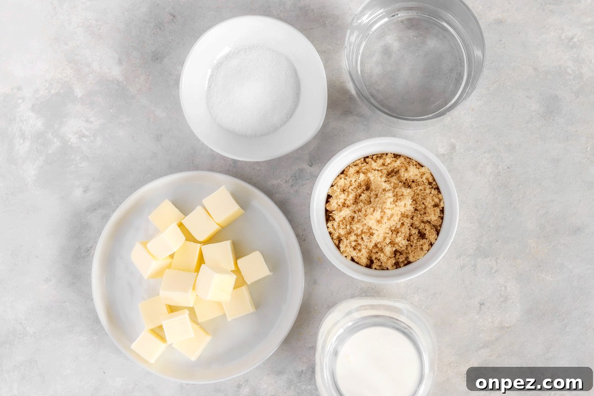 Brown sugar, butter, heavy cream, salt and water set out in bowls on a counter