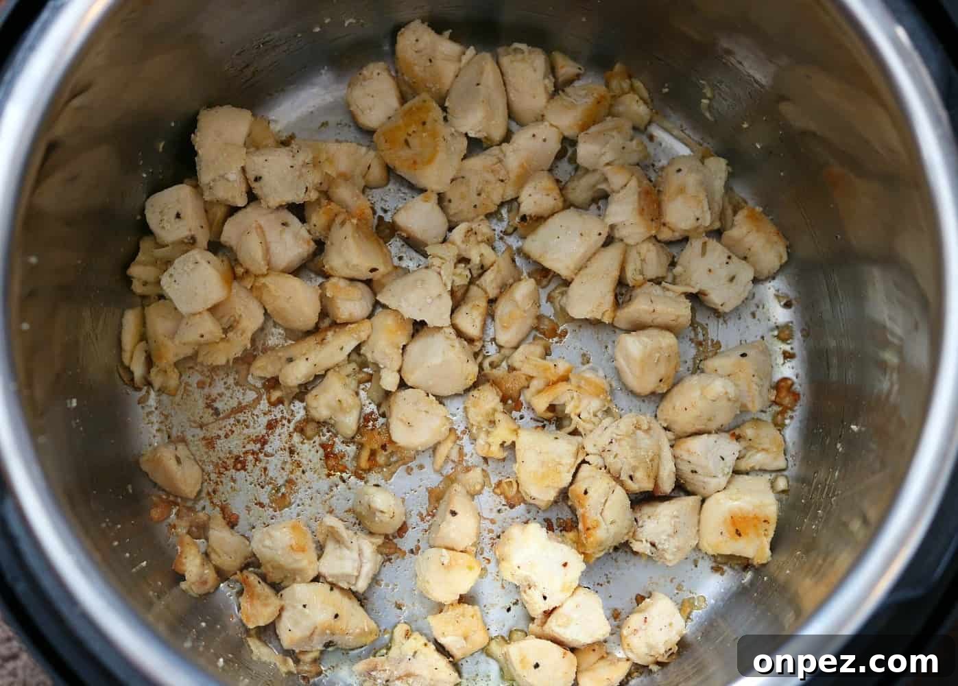 Instant Pot Spinach and Artichoke Chicken 5 Chicken sauteing in an Instant Pot