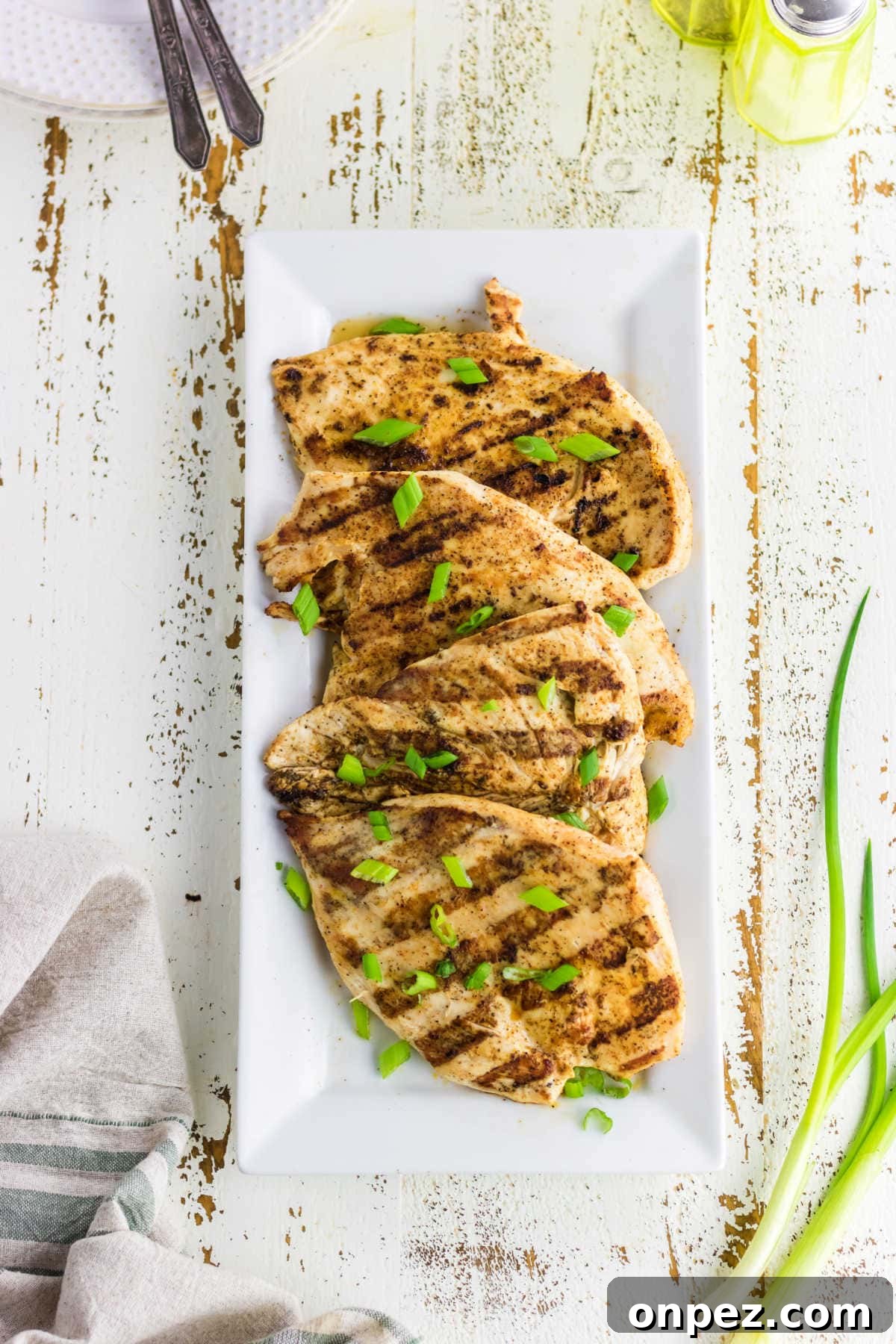 Juicy Cajun Grilled Chicken Breast Recipe 2 Overhead view of the grilled chicken on a white platter.