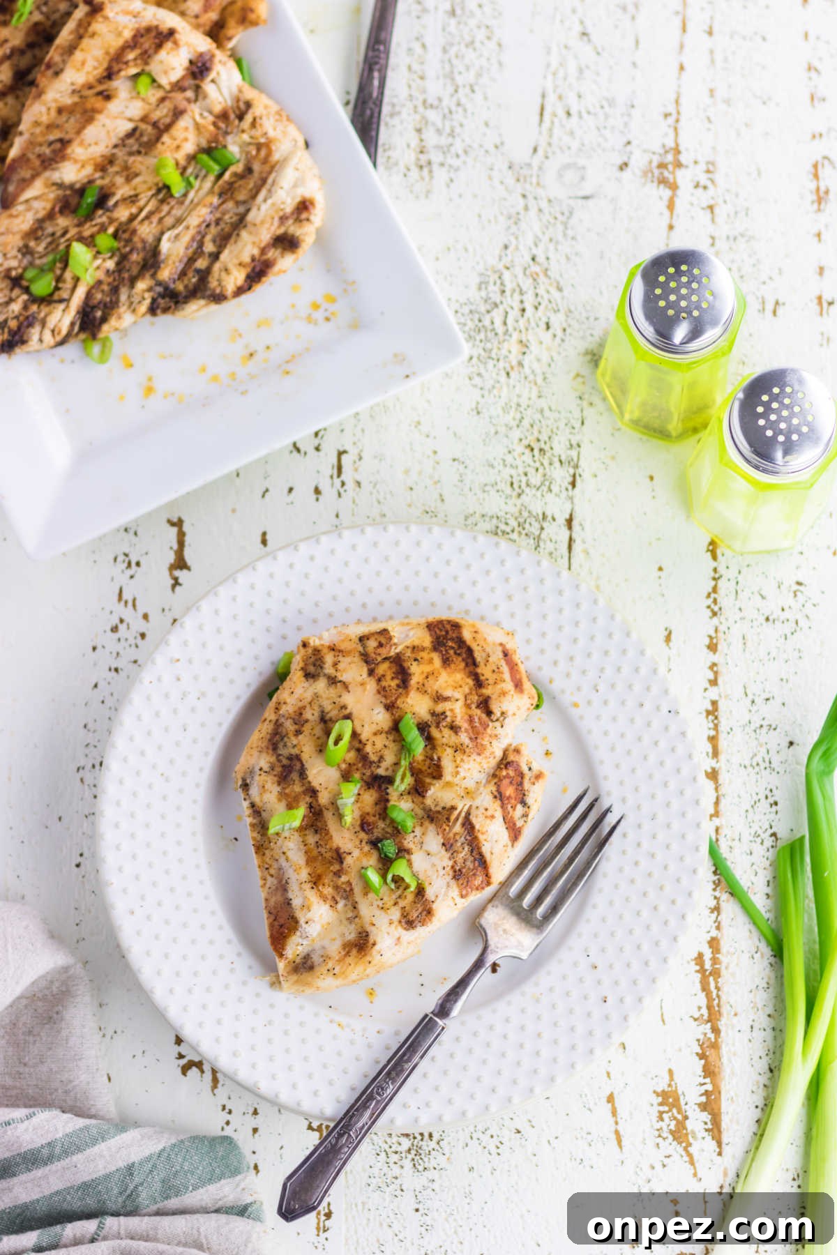 Juicy Cajun Grilled Chicken Breast Recipe 6 Chicken on a plate ready to eat.