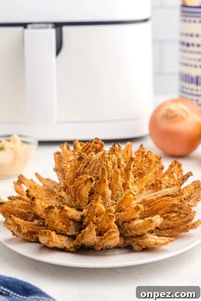 Golden crispy onion sliced open on a white plate 