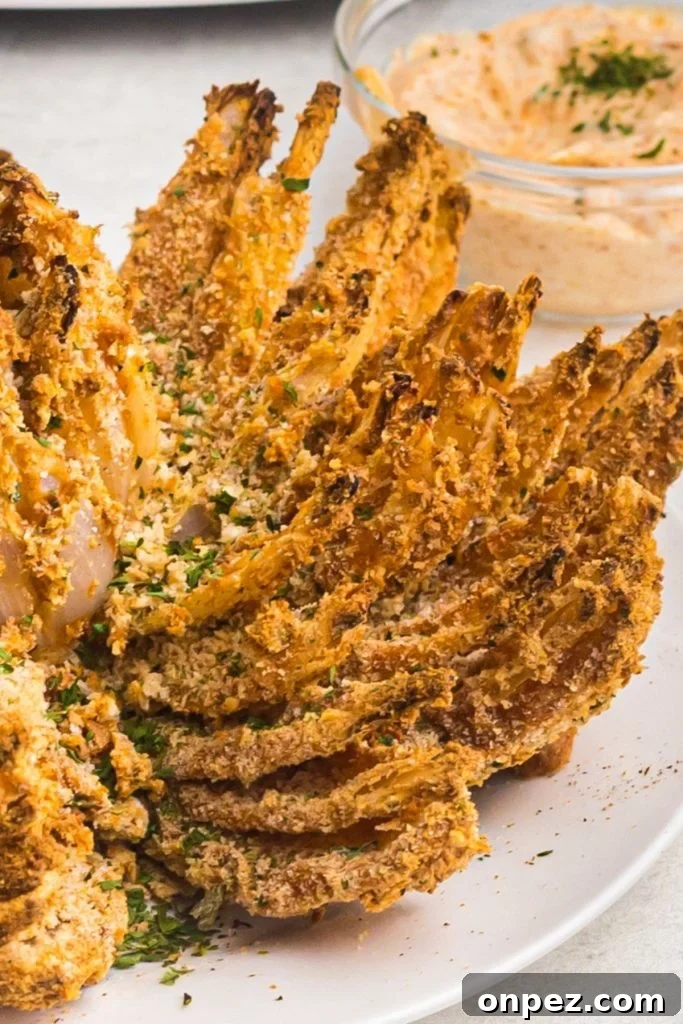 Golden crispy onion petals on a white plate 