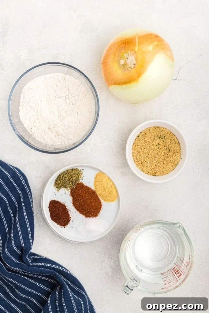 Ingredient for blooming onion, seasonings, breadcrumbs, onion, flour, on a white marble board