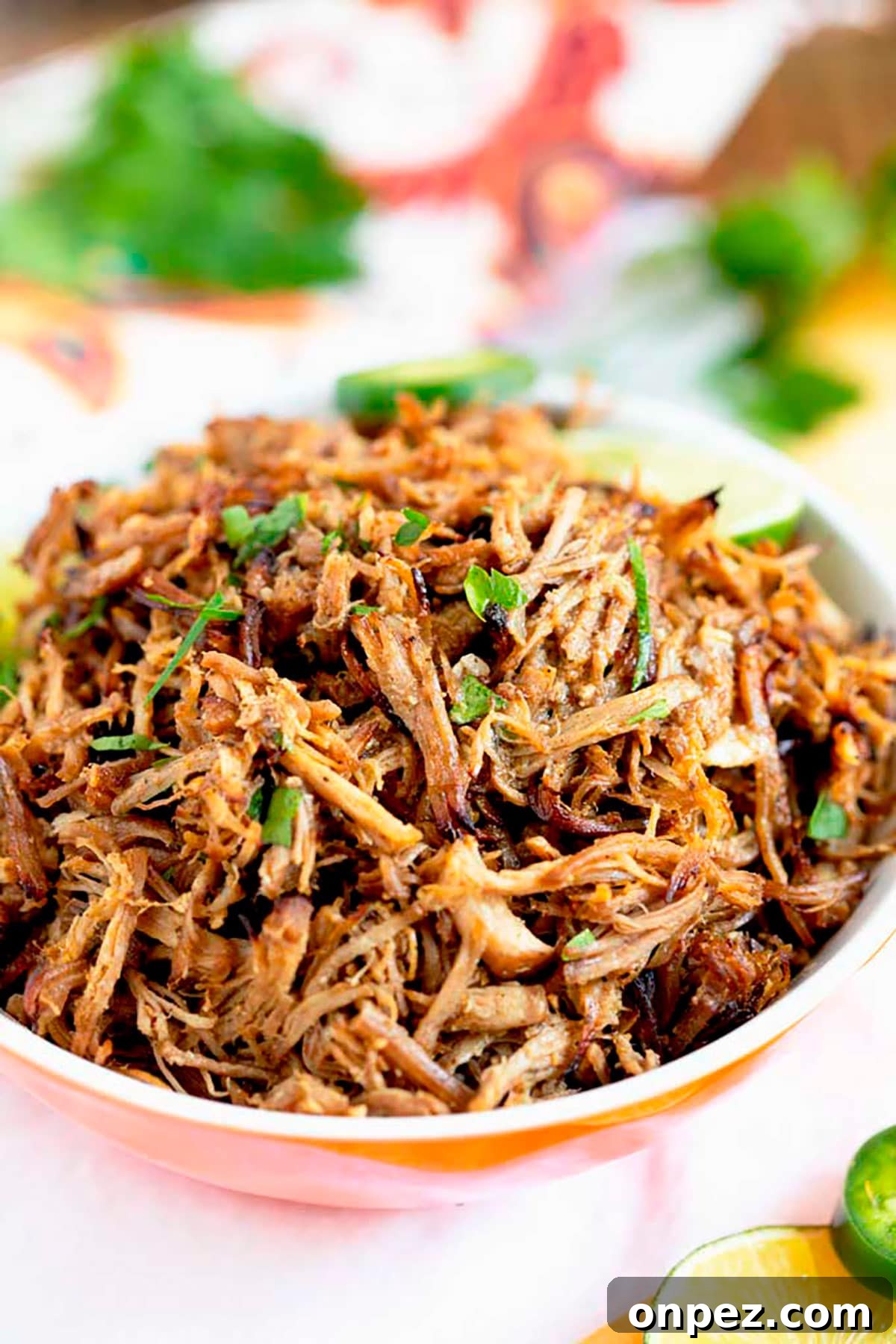 Instant Pot Pork Carnitas Recipe with Crispy Edges 3 Instant Pot Carnitas pile high in a serving bowl