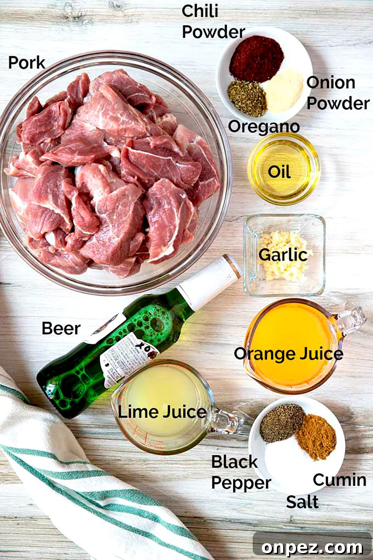 Instant Pot Pork Carnitas Recipe with Crispy Edges 4 Picture here all the ingredients to make this pork recipe on a white surface.
