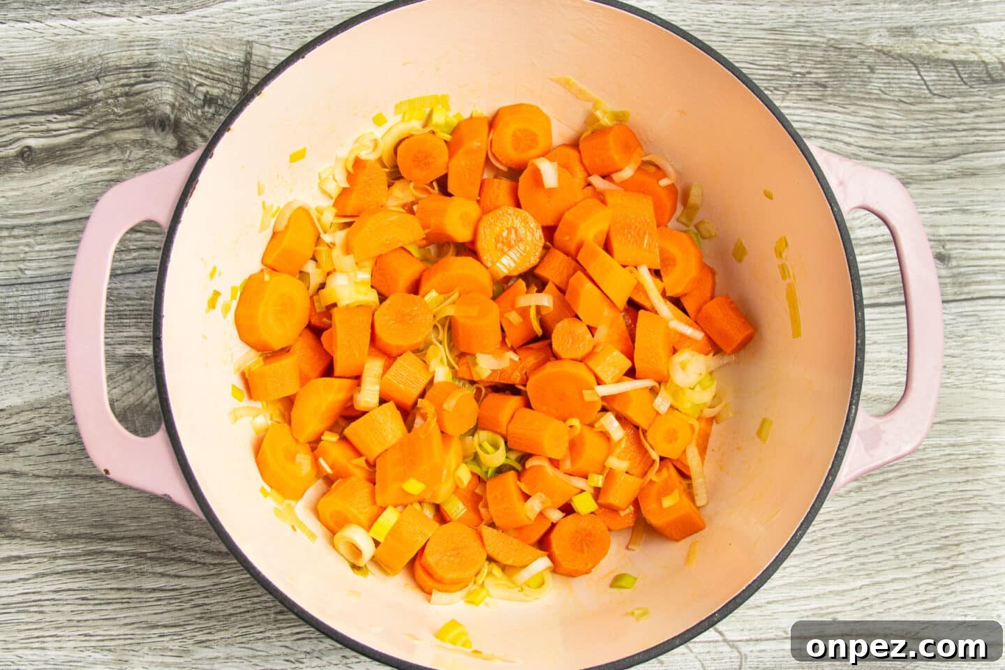 Roasted Carrot and Cauliflower Soup Recipe 4 Leeks and carrots cooking in a Dutch oven.