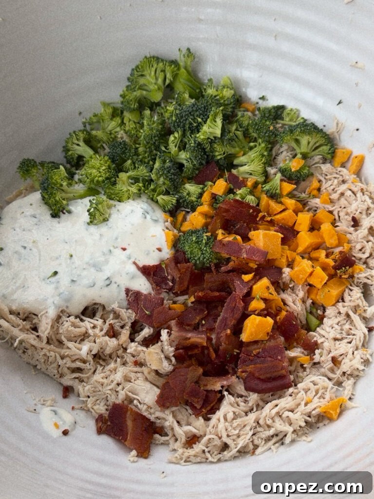 Chicken Salad with Bacon, Cheddar, and Ranch - Mayo-Free 3 Close up of chicken salad showing broccoli, cheddar, and bacon