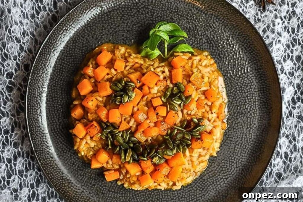 A plate of risotto decorated like a pumpkin face.
