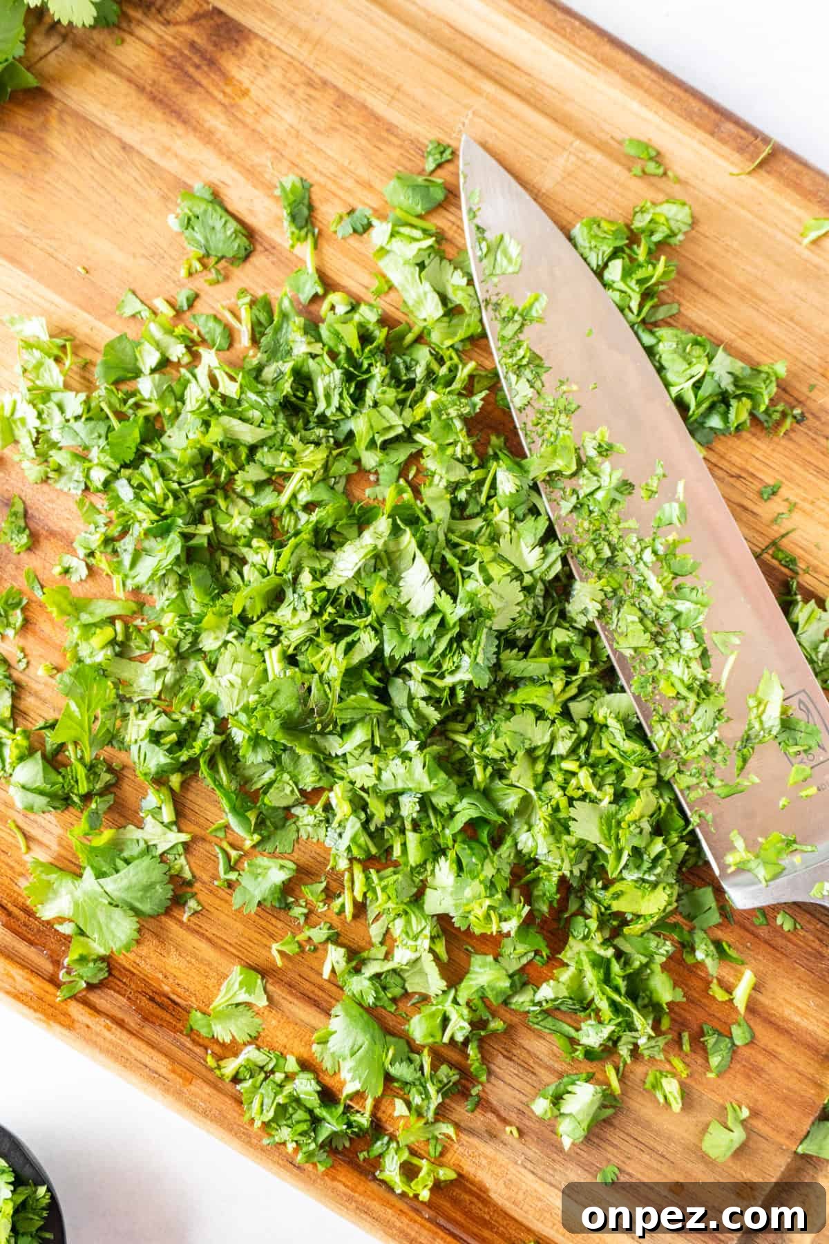 How to Chop Cilantro and Keep It Fresh 2 cilantro chopped on cutting board with knife