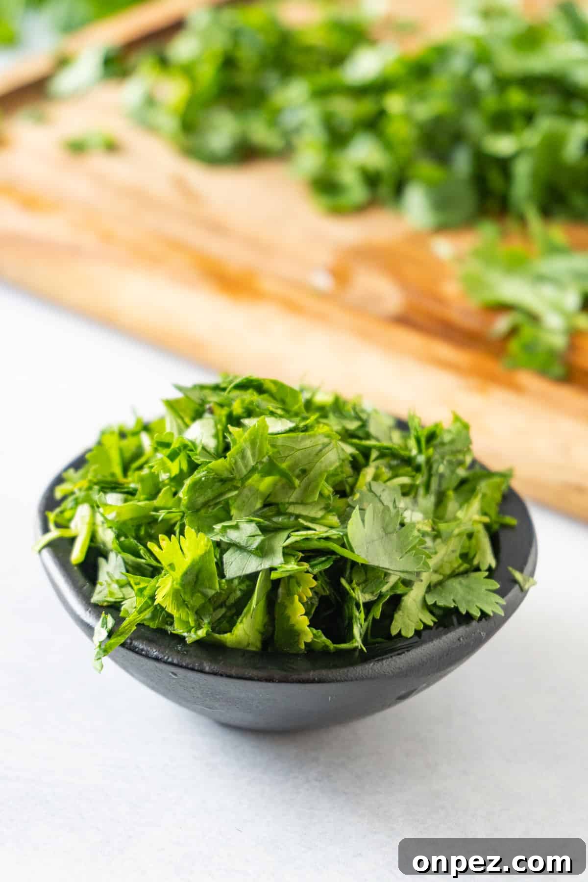 How to Chop Cilantro and Keep It Fresh 10 chopped cilantro in black bowl