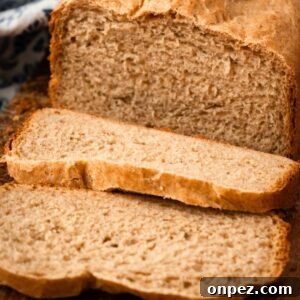 Honey Wheat Bread Recipe for Bread Machines 7 close up of honey wheat bread loaf with two slices cut.